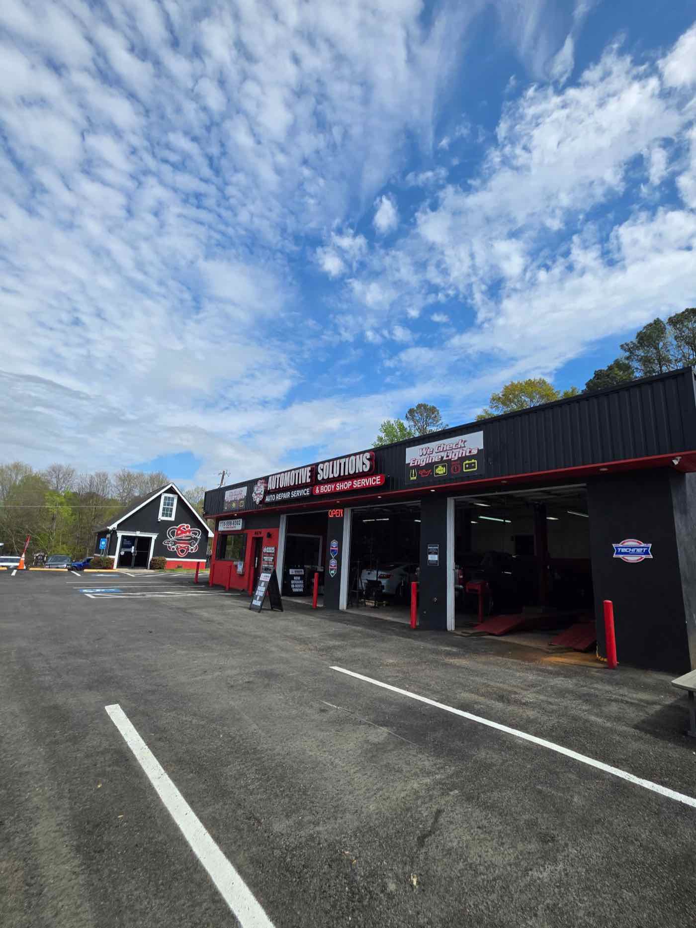 The Automotive Solutions building on Stone Mountain Highway with the service bays open