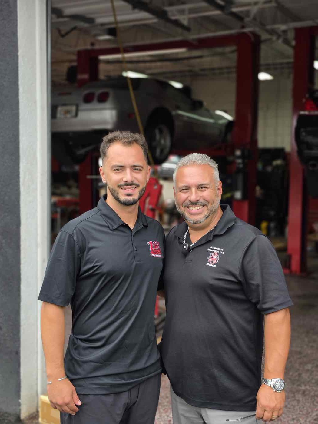Aldo Abboud and DeAngelo outside the service bays at Automotive Solutions