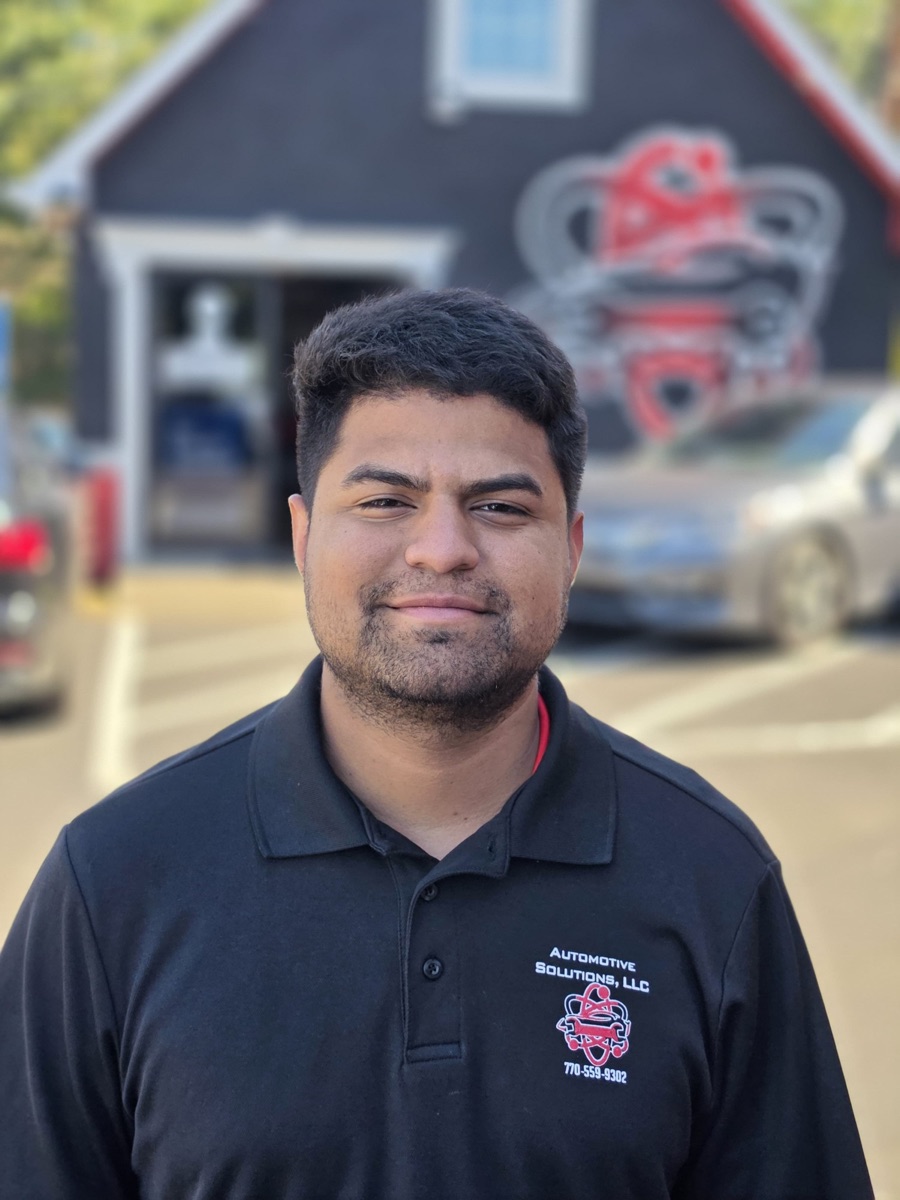 A body shop technician at Automotive Solutions, outside the shop