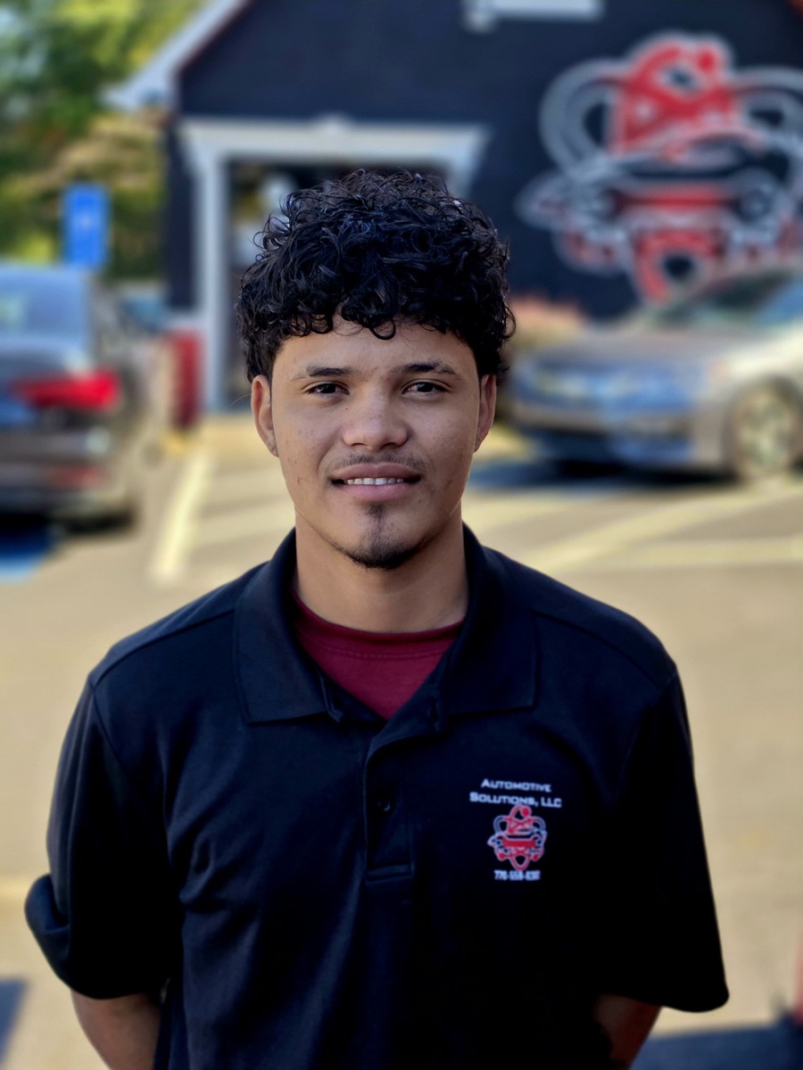 A body shop technician at Automotive Solutions, outside the shop