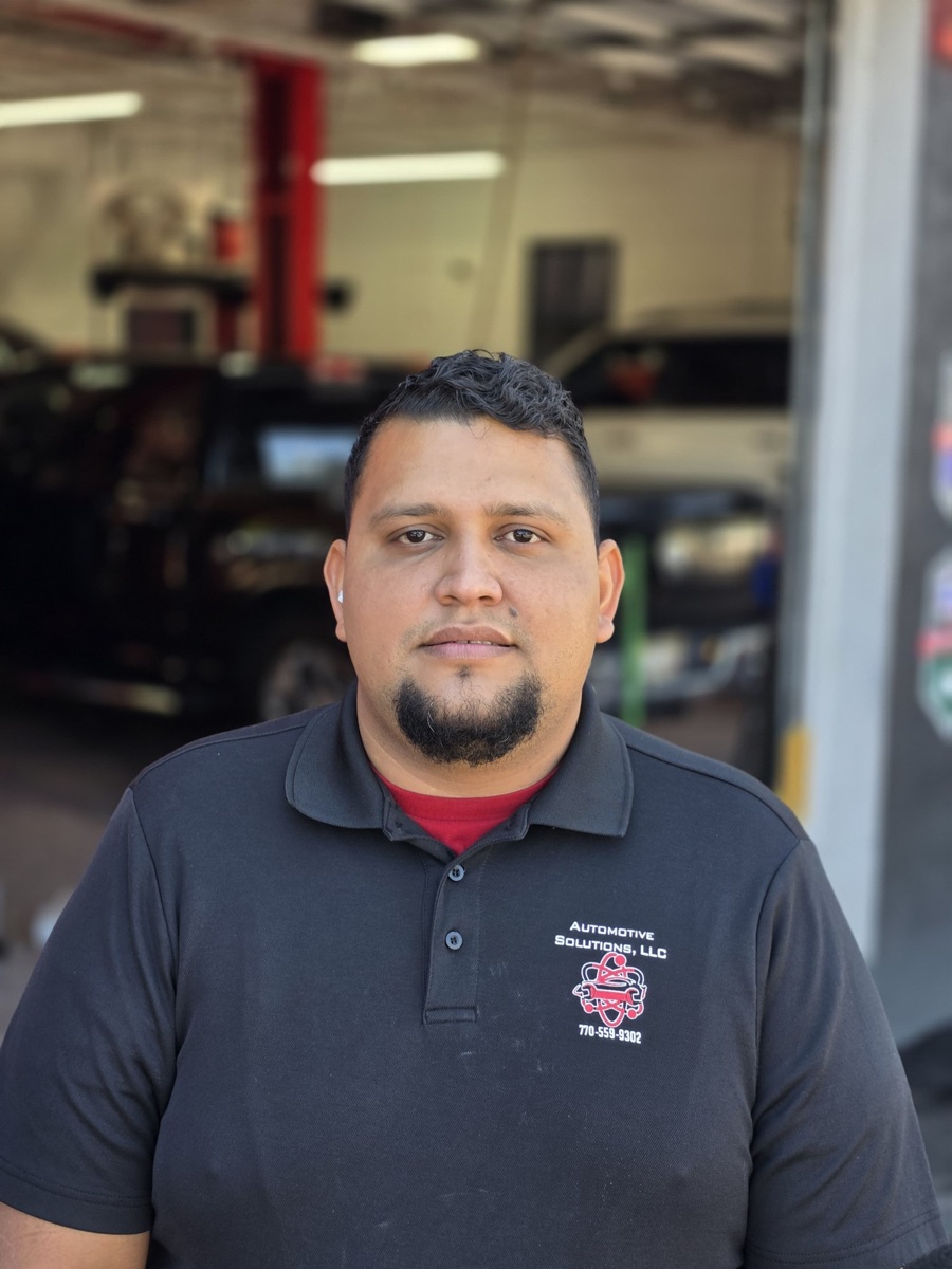 A body shop technician at Automotive Solutions, in the service bay