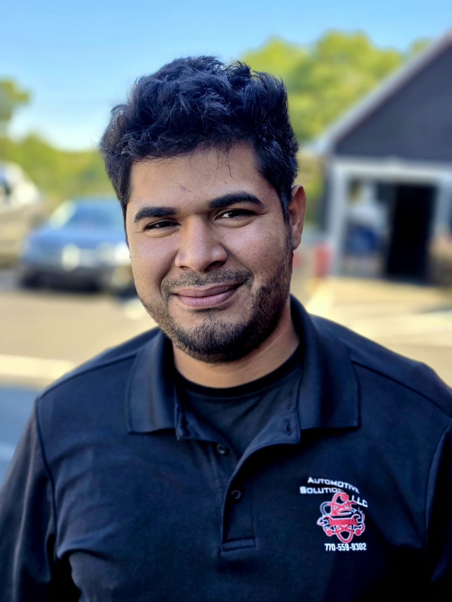 A body shop technician at Automotive Solutions, outside the shop
