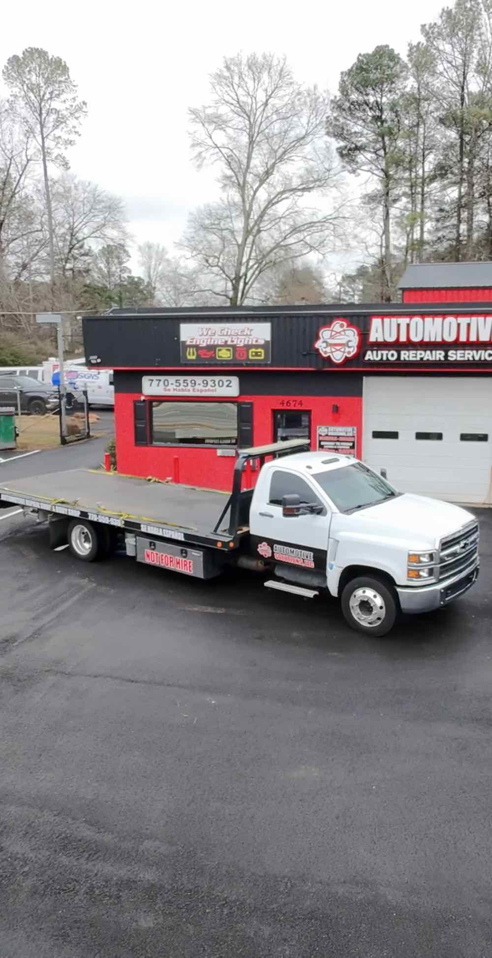The Automotive Solutions flatbed tow truck outside the Lilburn shop