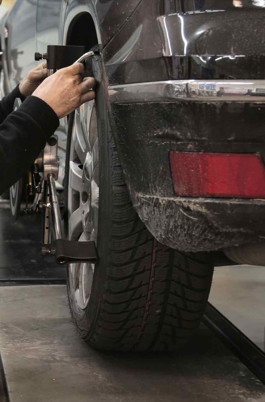 An alignment head clamped to a wheel on the alignment rack