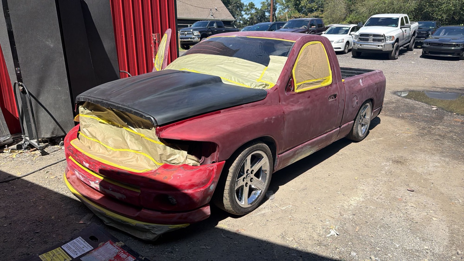 A Dodge Ram sanded and masked for paint outside the Automotive Solutions body shop