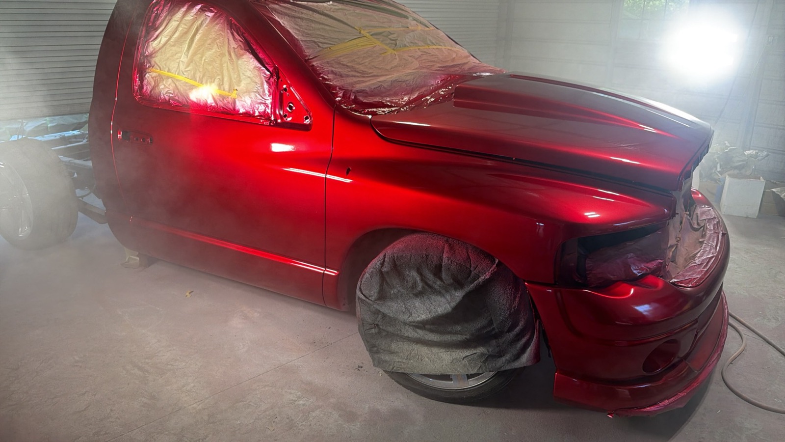 The same Ram in the paint booth with fresh candy red paint